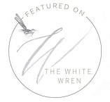 Circular logo with a sword and text 'Featured on The White Wren' in the center.