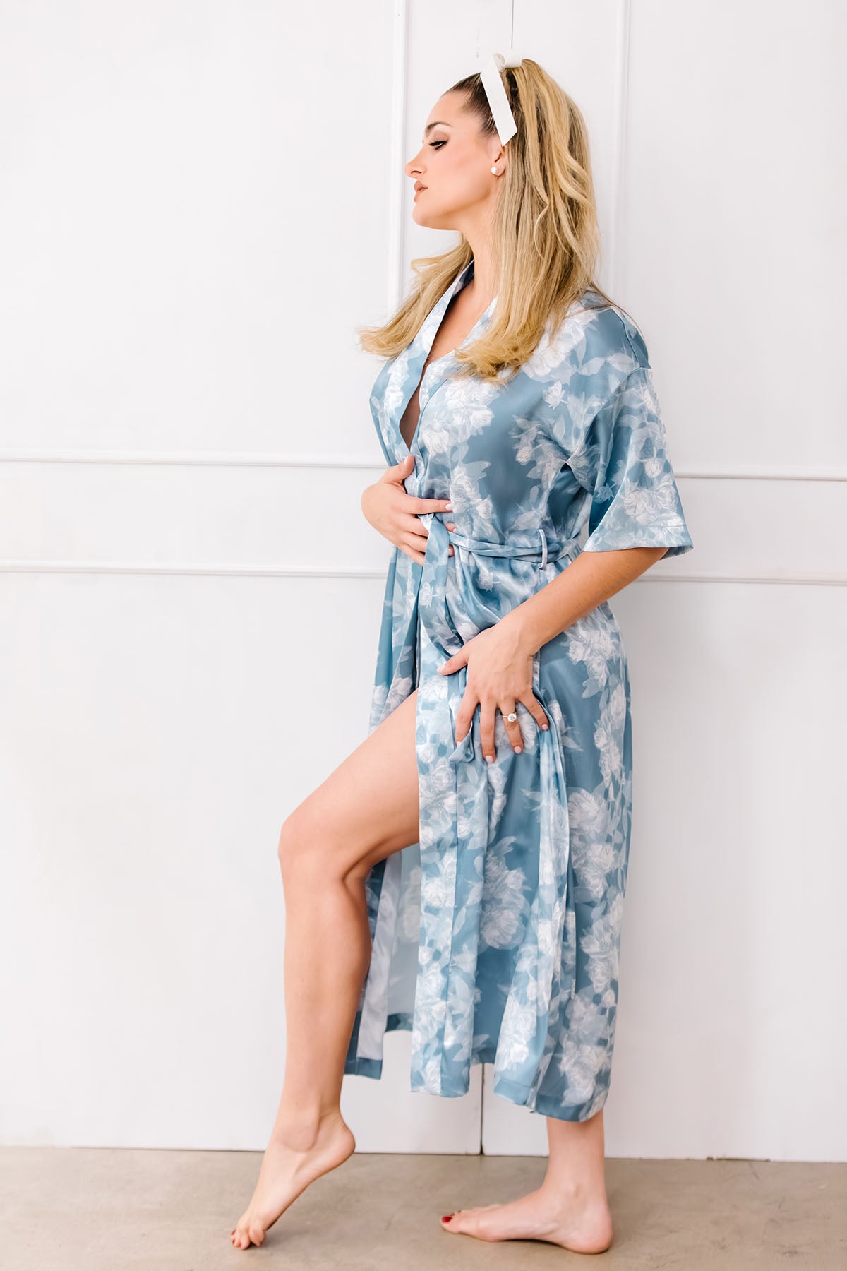 Woman wearing a blue floral robe against a white background