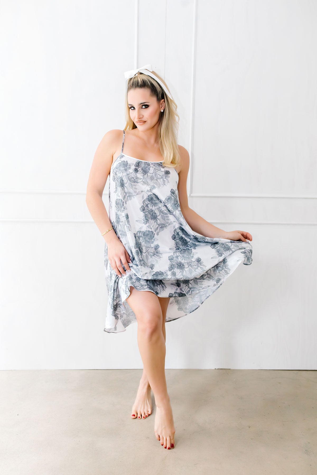 Woman wearing a floral dress against a white background