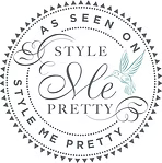 Decorative logo with 'Style Me Pretty' text and wings on a black background