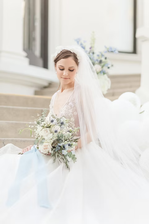 Bride holding a bouquet of flowers on a staircase