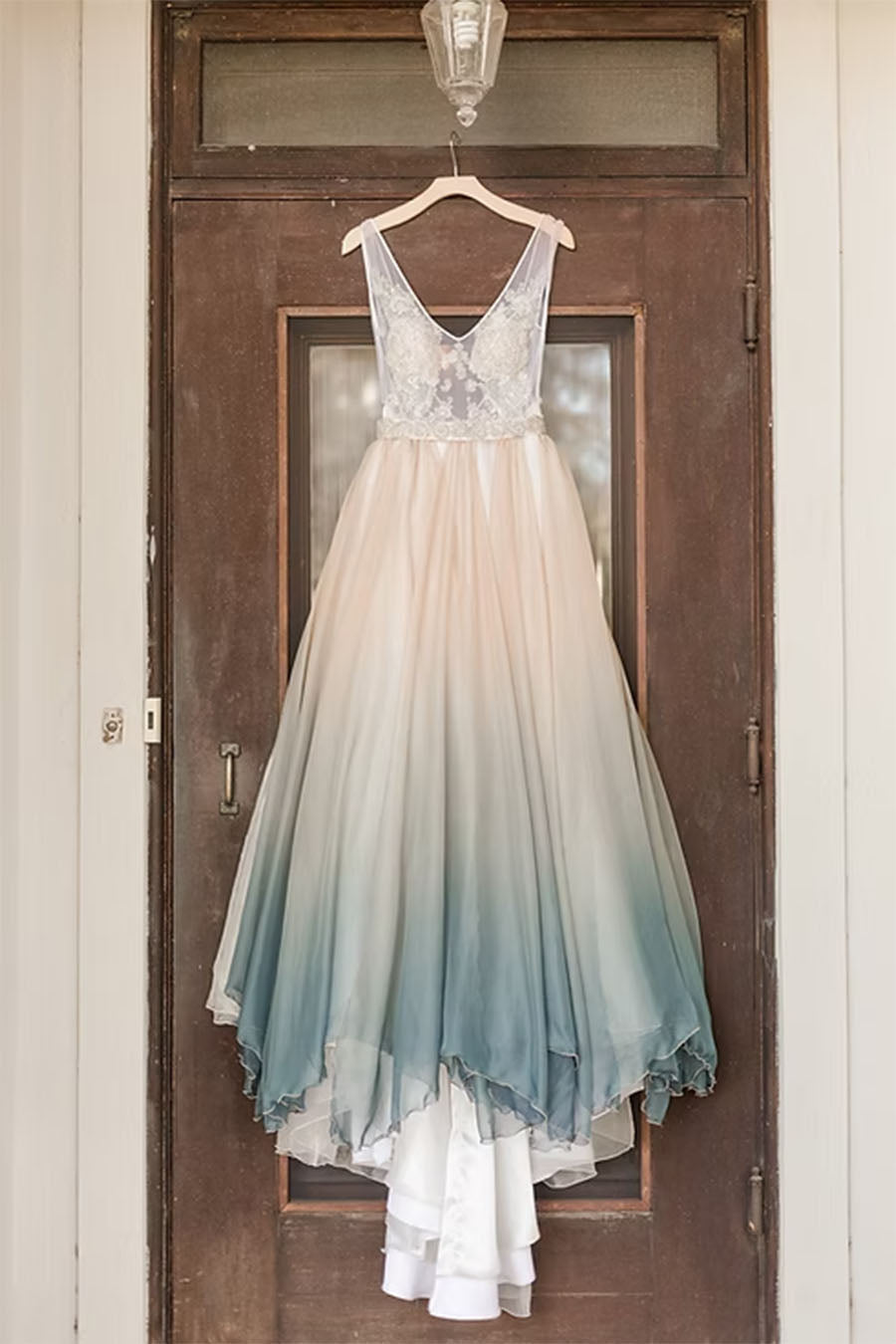 Gradient dress hanging on a wooden door