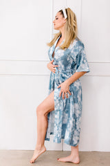 Woman wearing a blue floral robe against a white background