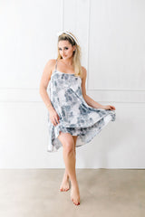 Woman wearing a floral dress against a white background